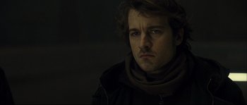 Movie still from “Empire of the Wolves” (2005), directed by Chris Nahon – A person wearing a jacket; Close Up shot, Low angle