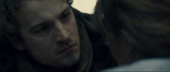 Movie still from “Empire of the Wolves” (2005), directed by Chris Nahon – A person with a beard; Close Up shot, Over the shoulder angle