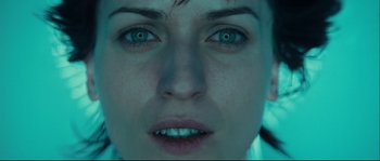 Movie still from “Empire of the Wolves” (2005), directed by Chris Nahon – A woman's face with green eyes; Extreme Close Up shot, Overhead angle