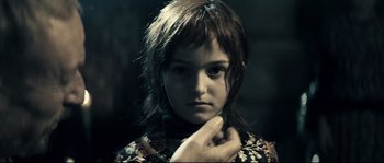 Movie still from “Empire of the Wolves” (2005), directed by Chris Nahon – A young girl with her hand under her chin; Close Up shot, Over the shoulder angle