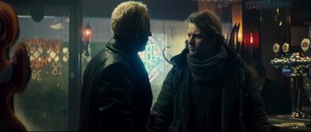 Movie still from “Empire of the Wolves” (2005), directed by Chris Nahon – Two men are talking in a dark room; Medium shot, Over the shoulder angle