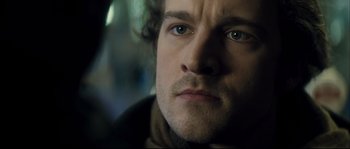 Movie still from “Empire of the Wolves” (2005), directed by Chris Nahon – A man's face in the dark; Close Up shot, Over the shoulder angle