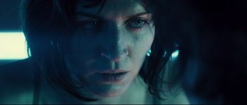 Movie still from “Empire of the Wolves” (2005), directed by Chris Nahon – A woman's face in a dark room; Extreme Close Up shot, Low angle