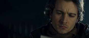 Movie still from “Empire of the Wolves” (2005), directed by Chris Nahon – A person with a beard; Close Up shot, Over the shoulder angle