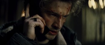 Movie still from “Empire of the Wolves” (2005), directed by Chris Nahon – A person talking on a cell phone; Close Up shot, Overhead angle