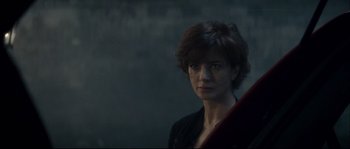 Movie still from “Empire of the Wolves” (2005), directed by Chris Nahon – A person with short hair; Close Up shot, Low angle