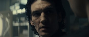 Movie still from “Empire of the Wolves” (2005), directed by Chris Nahon – A person with long dark hair; Close Up shot, Low angle