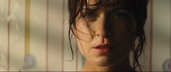 Movie still from “Empire of the Wolves” (2005), directed by Chris Nahon – A woman's face with wet hair; Close Up shot, Low angle