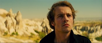 Movie still from “Empire of the Wolves” (2005), directed by Chris Nahon – A person looking at the camera; Close Up shot, Low angle