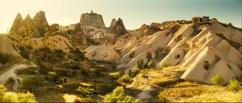 Movie still from “Empire of the Wolves” (2005), directed by Chris Nahon – A view of a mountain with a castle in the background; Extreme Wide shot, High angle