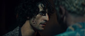 Movie still from “Empire of the Wolves” (2005), directed by Chris Nahon – A person wearing a black shirt; Close Up shot, Over the shoulder angle