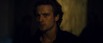Movie still from “Empire of the Wolves” (2005), directed by Chris Nahon – A person wearing a black shirt; Close Up shot, Over the shoulder angle