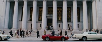 Movie still from “The Pursuit of Happyness” (2006), created by Frank Darabont – A red sports car driving down the street; Extreme Wide shot, High angle