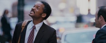 Movie still from “The Pursuit of Happyness” (2006), created by Frank Darabont – A person wearing a suit and tie; Close Up shot, Low angle