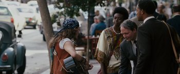 Movie still from “The Pursuit of Happyness” (2006), created by Frank Darabont – A group of people standing on a sidewalk; Medium shot, Over the shoulder angle