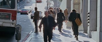 Movie still from “The Pursuit of Happyness” (2006), created by Frank Darabont – A group of people walking down a sidewalk; Wide shot, High angle
