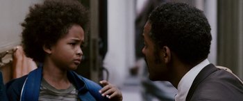 Movie still from “The Pursuit of Happyness” (2006), created by Frank Darabont – A man and a boy are looking at each other; Close Up shot, Over the shoulder angle