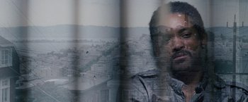 Movie still from “The Pursuit of Happyness” (2006), created by Frank Darabont – Double exposure of a man and a city skyline; Extreme Close Up shot, High angle