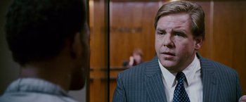 Movie still from “The Pursuit of Happyness” (2006), created by Frank Darabont – A man wearing a suit and tie talking to another man in a suit and tie; Close Up shot, Over the shoulder angle