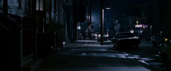 Movie still from “The Pursuit of Happyness” (2006), created by Frank Darabont – A city street at night lit by street lights; Extreme Wide shot, High angle