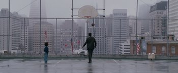 Movie still from “The Pursuit of Happyness” (2006), created by Frank Darabont – A man playing basketball on the court; Extreme Wide shot, Low angle