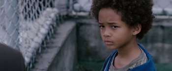 Movie still from “The Pursuit of Happyness” (2006), created by Frank Darabont – A young boy with a blue shirt; Close Up shot, High angle