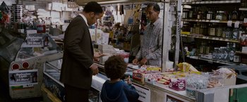 Movie still from “The Pursuit of Happyness” (2006), created by Frank Darabont – Two men in a store talking to a young boy; Medium shot, Over the shoulder angle