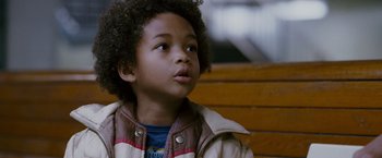 Movie still from “The Pursuit of Happyness” (2006), created by Frank Darabont – A young child looking up; Close Up shot, High angle