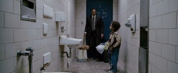 Movie still from “The Pursuit of Happyness” (2006), created by Frank Darabont – A man and a child in a bathroom; Medium shot, Over the shoulder angle
