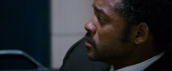 Movie still from “The Pursuit of Happyness” (2006), created by Frank Darabont – A man with a beard looking to his left; Close Up shot, Over the shoulder angle