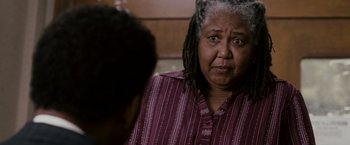Movie still from “The Pursuit of Happyness” (2006), created by Frank Darabont – An older woman with dreadlocks talking to a younger person; Close Up shot, Over the shoulder angle