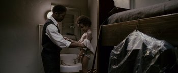 Movie still from “The Pursuit of Happyness” (2006), created by Frank Darabont – A man and a woman in a bathroom; Medium shot, Over the shoulder angle