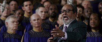 Movie still from “The Pursuit of Happyness” (2006), created by Frank Darabont – An older man in a crowd of people; Close Up shot, Low angle
