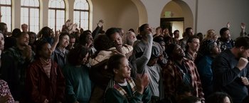Movie still from “The Pursuit of Happyness” (2006), created by Frank Darabont – A group of people gathered in a room; Medium shot, High angle