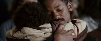 Movie still from “The Pursuit of Happyness” (2006), created by Frank Darabont – A person holding a banana; Close Up shot, Over the shoulder angle