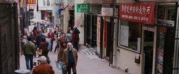 Movie still from “The Pursuit of Happyness” (2006), created by Frank Darabont – A group of people walking down a street; Wide shot, High angle