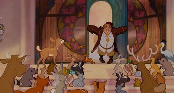 Movie still from “Enchanted” (2007), directed by Kevin Lima – A group of animals gathered around a man in a brown jacket; Wide shot, Over the shoulder angle