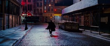 Movie still from “Enchanted” (2007), directed by Kevin Lima – A person riding a skate board on a wet street; Wide shot, Low angle