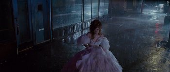 Movie still from “Enchanted” (2007), directed by Kevin Lima – A woman in a white ball gown in the rain; Wide shot, High angle