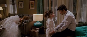 Movie still from “Enchanted” (2007), directed by Kevin Lima – A man and a little girl standing in a living room next to each other; Medium shot, Over the shoulder angle