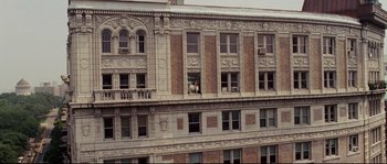 Movie still from “Enchanted” (2007), directed by Kevin Lima – A person is looking out of a window on a building; Extreme Wide shot, High angle
