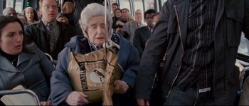 Movie still from “Enchanted” (2007), directed by Kevin Lima – An old woman holding a bag on a crowded bus; Medium shot, High angle