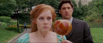 Movie still from “Enchanted” (2007), directed by Kevin Lima – A woman and a man looking at a cake pop; Close Up shot, Over the shoulder angle
