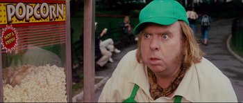 Movie still from “Enchanted” (2007), directed by Kevin Lima – A person wearing a green hat; Close Up shot, Over the shoulder angle