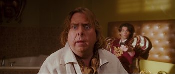 Movie still from “Enchanted” (2007), directed by Kevin Lima – A person wearing a shirt and tie; Close Up shot, Over the shoulder angle