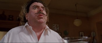 Movie still from “Enchanted” (2007), directed by Kevin Lima – A person wearing a shirt with a mustache; Close Up shot, Low angle