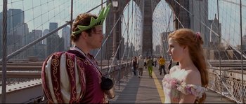 Movie still from “Enchanted” (2007), directed by Kevin Lima – A man and a woman dressed in costumes on a bridge; Medium shot, Over the shoulder angle