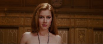 Movie still from “Enchanted” (2007), directed by Kevin Lima – A woman with long red hair wearing a necklace; Close Up shot, Over the shoulder angle