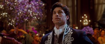 Movie still from “Enchanted” (2007), directed by Kevin Lima – A man wearing a suit and a white tie; Close Up shot, Over the shoulder angle