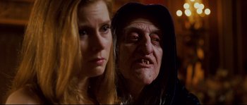 Movie still from “Enchanted” (2007), directed by Kevin Lima – A woman standing next to an old witch; Close Up shot, Over the shoulder angle